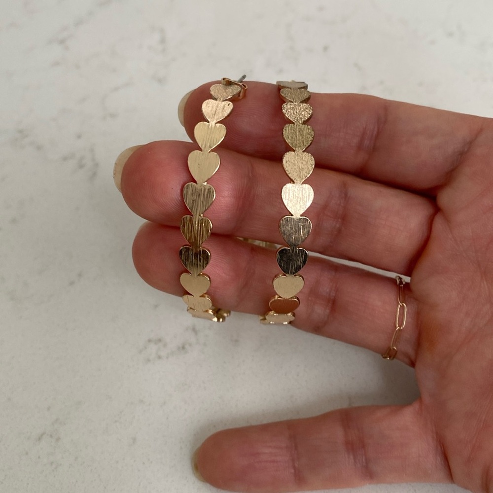 Fun heart hoop earrings. Gold color. 2” wide.
